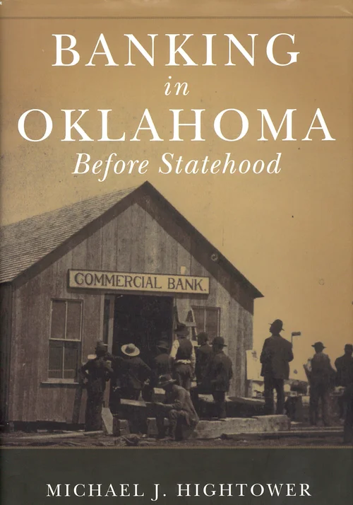 Book cover of “Banking in Oklahoma Before Statehood” by Michael J. Hightower, featuring a sepia historical photograph of people gathered outside a frontier-era wooden Commercial Bank building