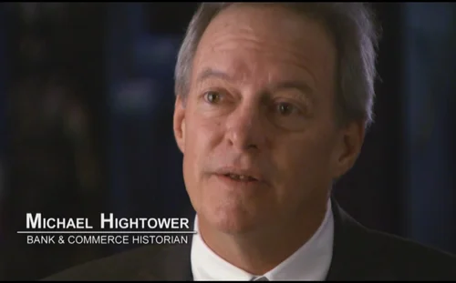 Video still of Michael Hightower, identified on screen as Bank & Commerce Historian, speaking directly to the camera